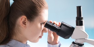 Doctor woman look at the laboratory microscope